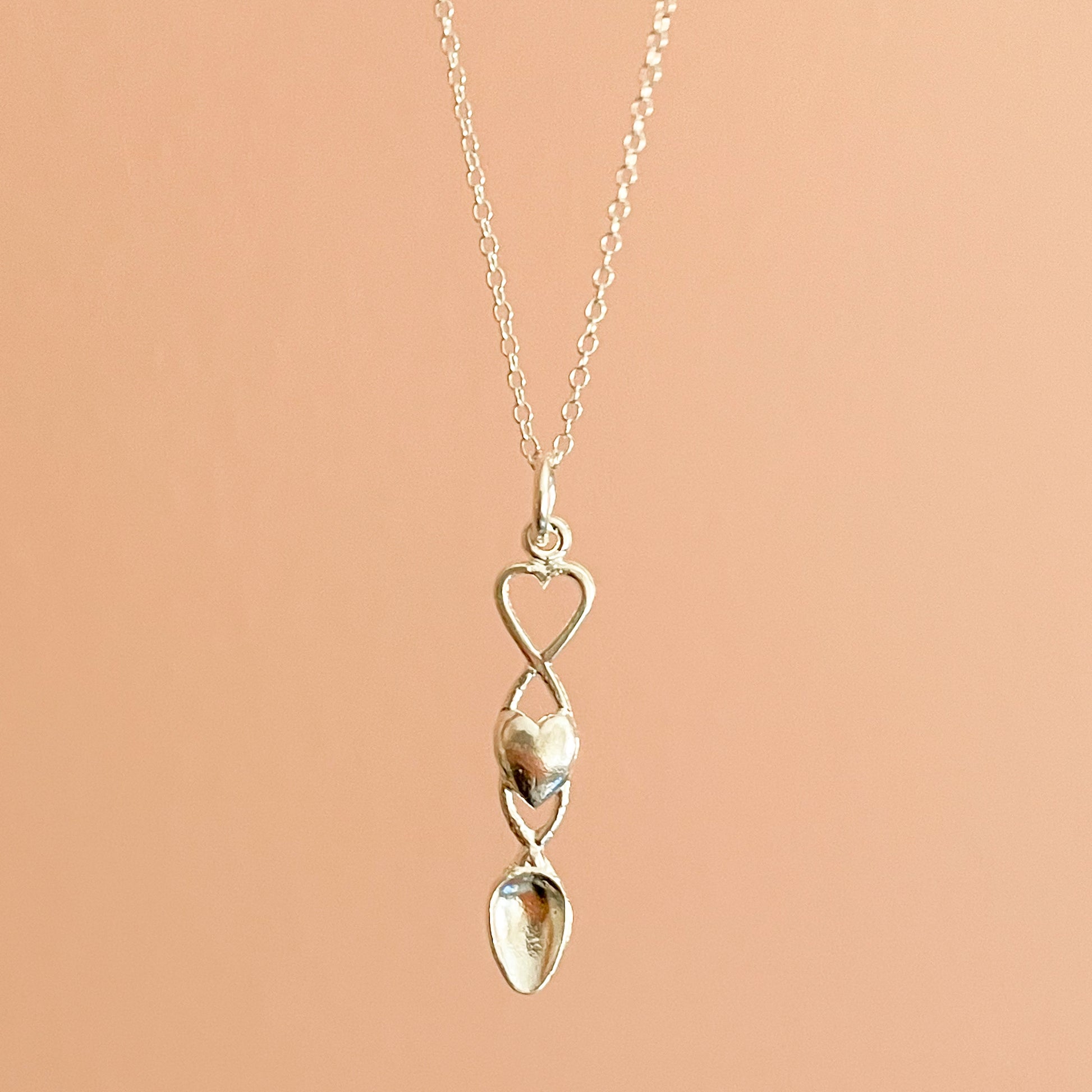 Silver tone necklace with a spoon pendant, stamped with 